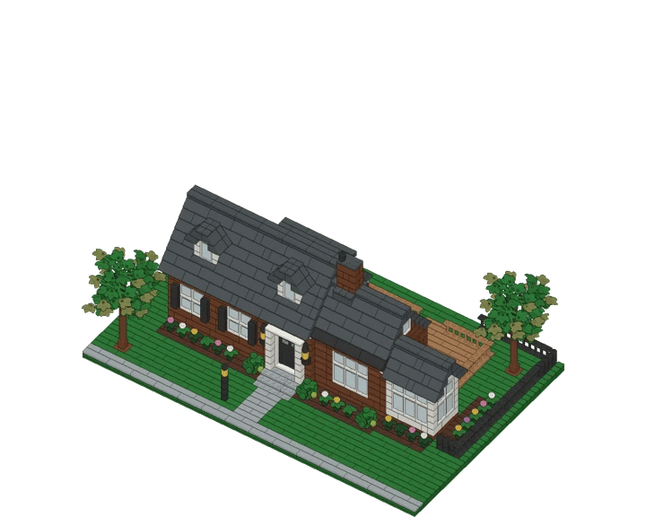 A 2,000-piece brick model of a house with a dark gray roof, dormers, a sunroom, deck and trees