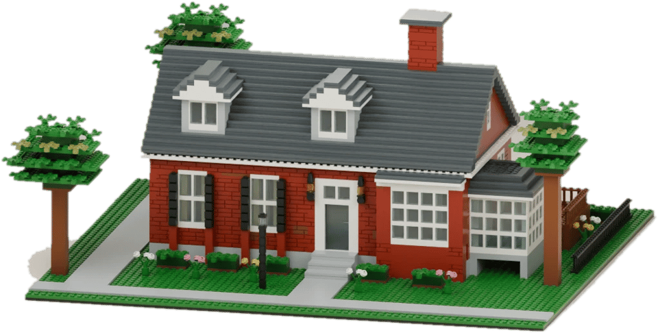 Brick model of a red brick house with dormer windows, a sunroom and leafy trees